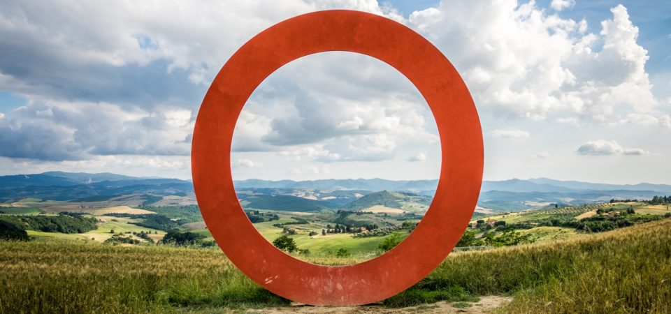A red circle set against a Tuscan landscape by Giuseppe Milo