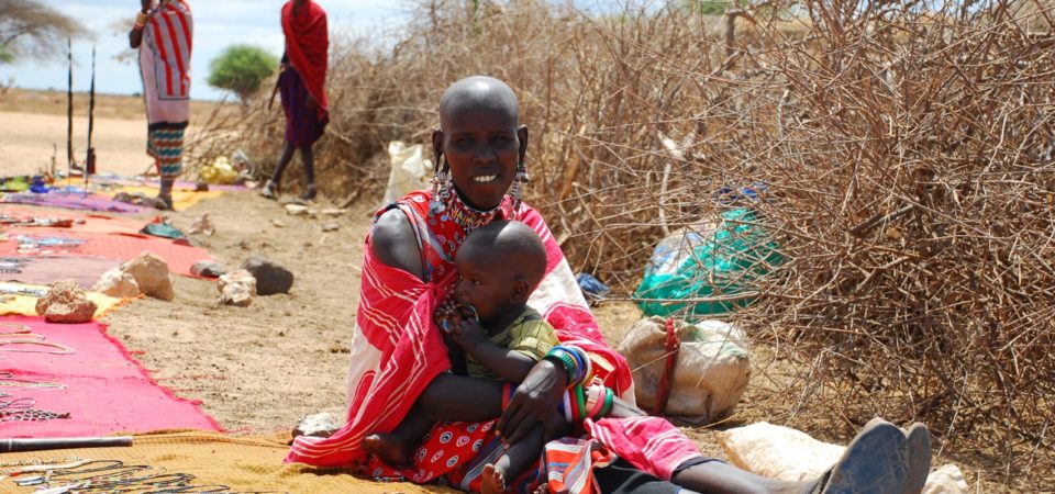 Kenyan woman and child, sitting on floor